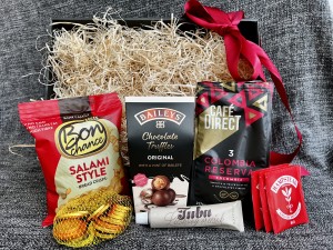 A large black package with a transparent lid containing ground Colombia coffee - Reklamnepredmety